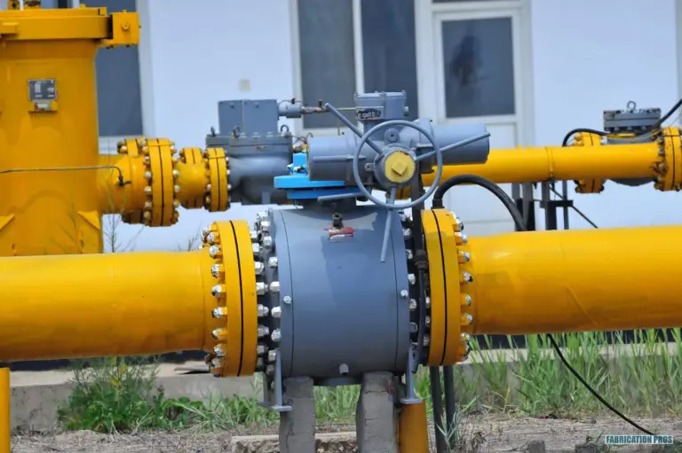 Yellow process piping with a large flanged valve