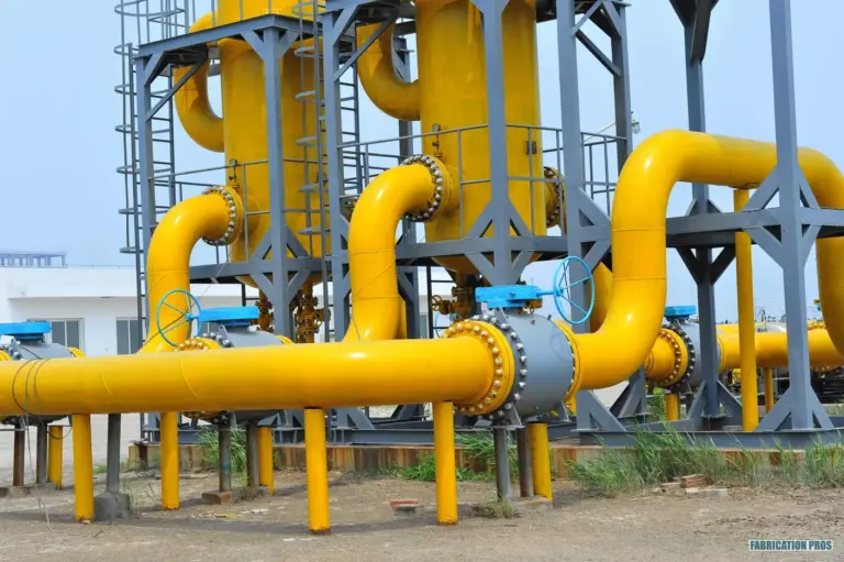 Yellow high-pressure gas piping and valves at a facility