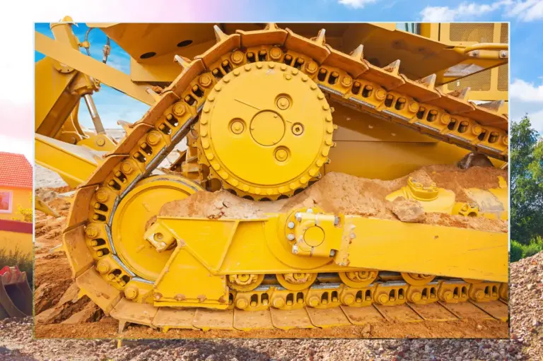 Close-up of a yellow excavator track and undercarriage