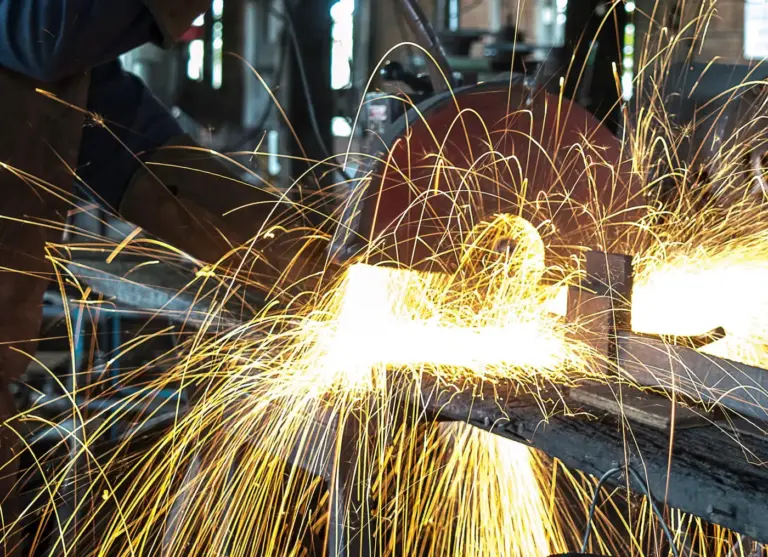 Sparks from cutting a steel beam with a chop saw