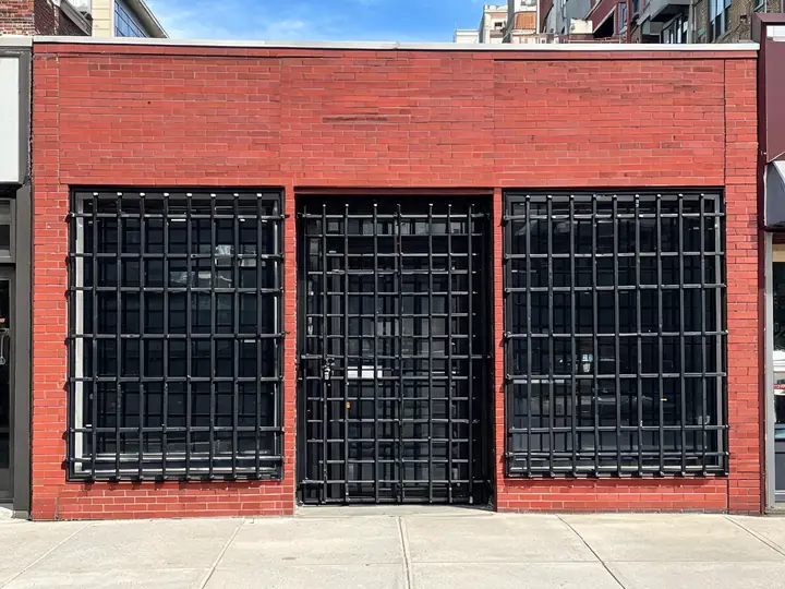 Black welded steel security bars over storefront windows and door